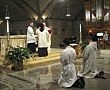 Dat Q. Tran, CSP (left), kneels as Bishop Francisco Gonzalez Valer, SF, recites the prayer of consecration during Mr. Trans ordination to the transitional diaconate.