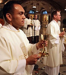 Rev. Mr. Rene I. Constanza, CSP (left) and Rev. Mr. Richard R. Andre, CSP, prepare to offer the Blood of Christ during the Mass in which they were ordained deacons in the Paulist community.