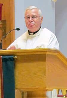 Father Paul G. Robichaud, CSP, delivers the homily during Mass after the Paulist Open.