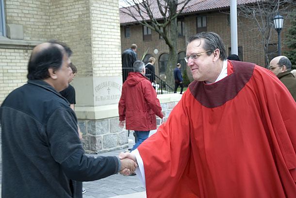 Father Mark-David Janus, CSP, greets a parishioner at the Cathedral of St. Andrew in Grand Rapids, Mich. Paulist Reconciliation Ministries has hosted to national conferences to guide parishes in bringing those who are alienated back to the church. Eleven Paulist-run pairshes and centers have established reconciliation ministries.