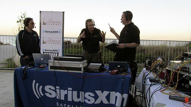 Executive Producer Robyn Gould (left), "Pusedo Phone Boy" Brett Siddell and Fatehr Dave Dwyer, CSP, host, broadcast the "Busted Halo Radio Show" live from the welcome clam bake of the Third Annual Paulist Open in Vero Beach, Fla.