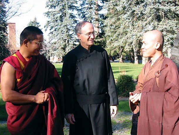 Father Thomas Ryan, C.S.P. (center) talks with two Buddhist monks at an inter-religious event. The Paulist mission includes hhigh engagement in interfaith and ecumenical dialogue. Some 459 Paulist parishioners are engaged in this ministry.