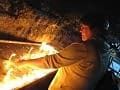 <emPilgrim Kathleen Lossau lights a candle in Elijah's Cave at the Basilica of the Blessed Virgin Mary at Mount Carmel.pty>