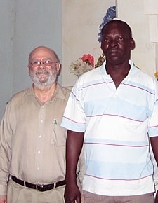Father John Behnke, CSP, stands with Brother Dominique in St. Anne's Cathedral in Thies, Senegal.