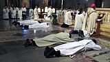 Three Paulist and two members of the Order of Friars Minor lay prostrate before the altar during their diaconal ordination. (Photo credit: Bruce Byers, brucebyers.com)