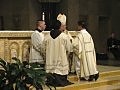 <emBishop Francisco Gonzalez Valer, SF, presents Rev. Mr. Dat Q. Tran, CSP, with the Book of Gospels during Rev. Mr. Tran's ordination as a transitional deacon.pty>