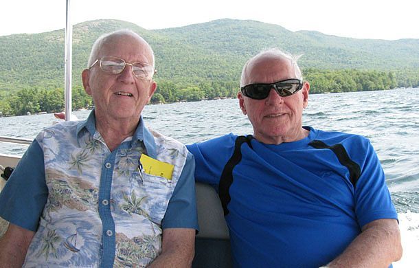 Father Ken McGuire, CSP (left), and Father George Fitzgerald, CSP, take a boat ride on Lake George.