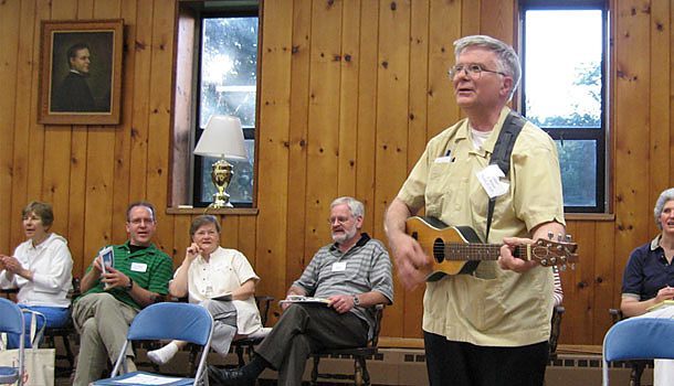 Father D. Bruce Nieli, C.S.P., plays his backpacker guitar during a session of the East Coast Holy Spirit retreat.