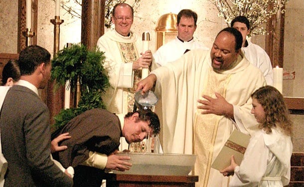 Father Steven Bell, CSP, baptizes a man during the Easter Vigil at St. Austin Church in Austin, Texas. Paulist-run parishes and centers welcomed almost 200 catechumens and candidates to the church in 2011.