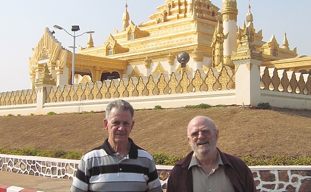 Tom Garrett (left) and Father John Behnke, CSP, stand in front of a Buddhist temple in Mandalay, Myanmar (Burma).