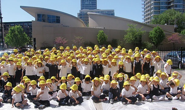 Students at Old St. Mary’s School in Chicago pose for a group photo during the ground breaking ceremony for a new school building.