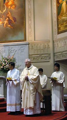 Father Daniel McCotter, CSP (front right), pastor of Old St. Mary's and Holy Family, and Deacon Simon Tsui, lead the Aug. 26 unity Mass.