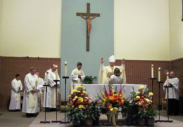 Bishop Lee Piche of the Archdiocese of St. Paul and Minneapolis (with arms extended) offers the final blessing at the 125th anniversary Mass at St. Lawrence Church and Newman Center in Minneapolis Nov. 3.