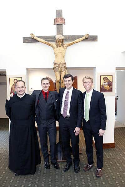Daniel Arthur, Evan Cummings, Paolo Puccini, and Michael Cruickshank stand outside the St. Paul's College Chapel before the Mass where they made their first promise with the Paulist community.