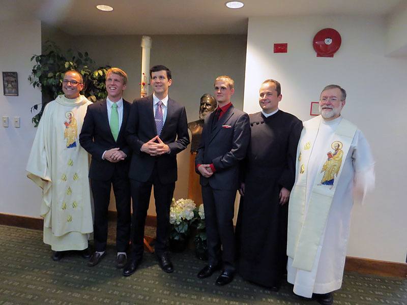 Paulist President Eric Andrews (left); Michael Cruickshank CSP; Paolo Puccini, CSP; Evan Cummings, CSP; Daniel Arthur, CSP; and Paulist Novicemaster Father Rich Colgan gather for a photo op after the Mass during which the four men made their first promise with the Paulist community.