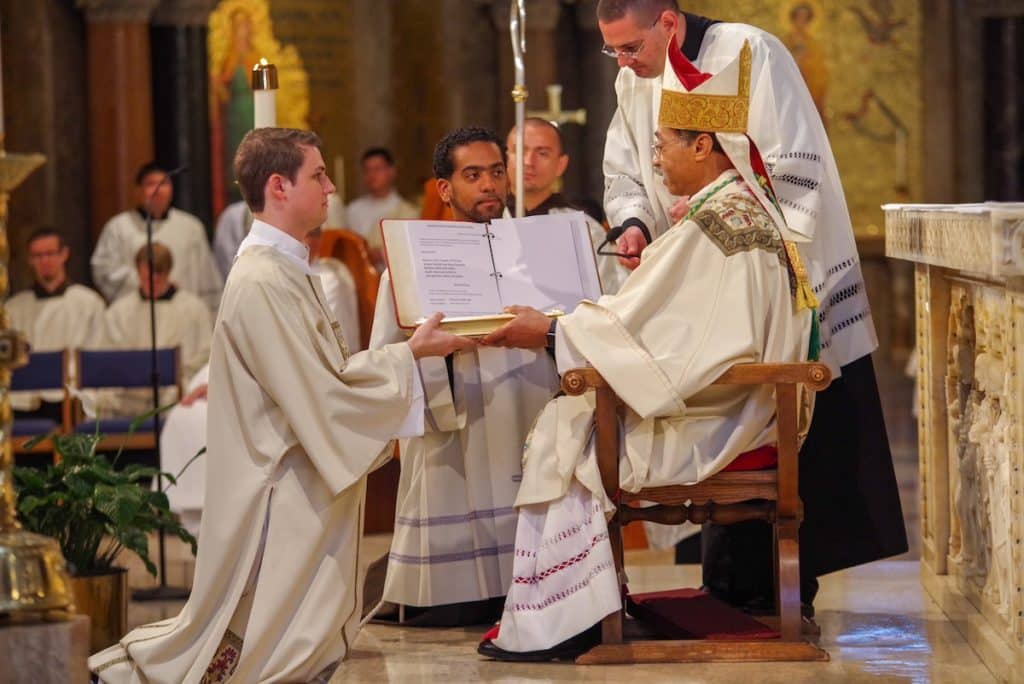 brand_new_deacon_paulist_evan_cummings_presented_book_of_the_gospels_at_diaconate_ordination_mass