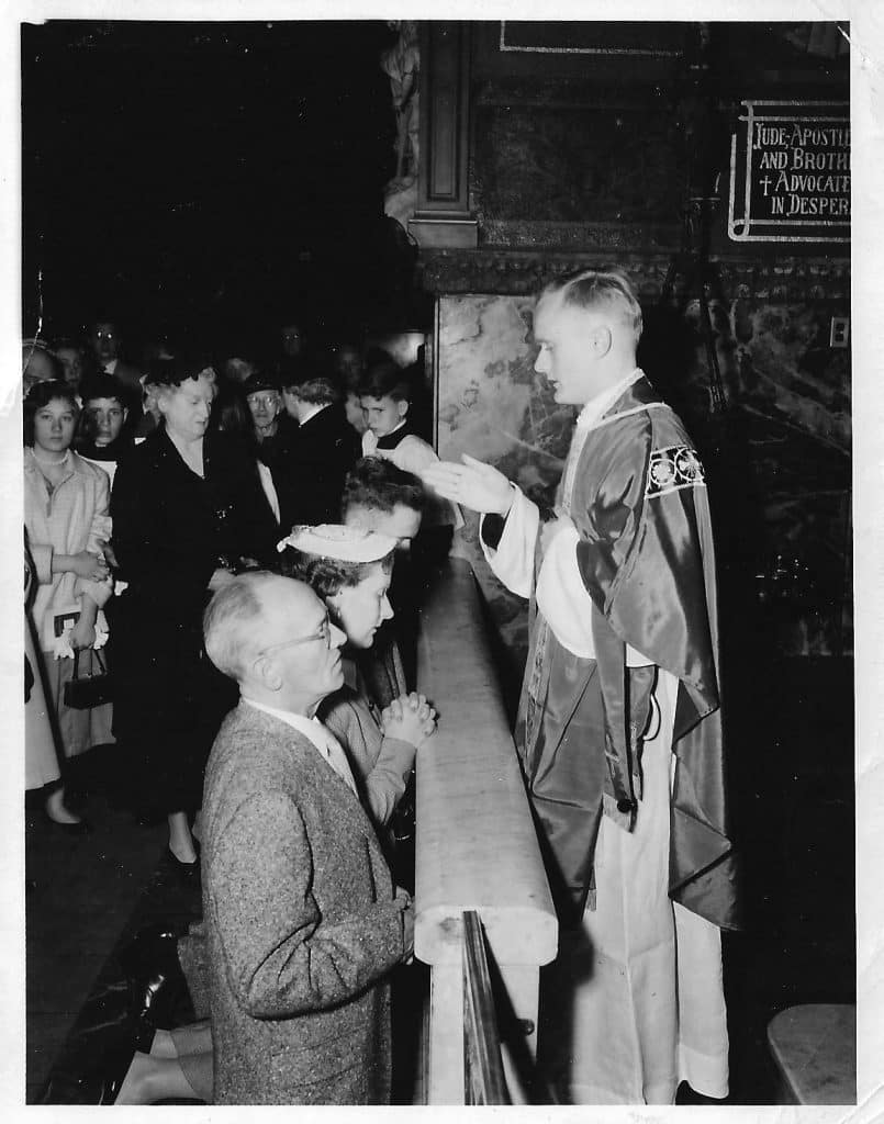 Paulist_Fr._James_McQuade_giving_his_first_priestly_blessing_to_his_parents_on_May_3_1956