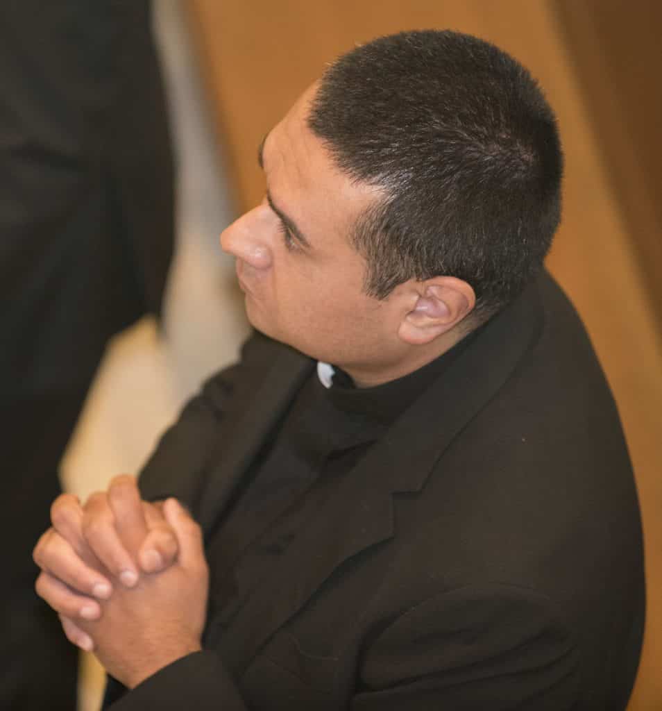 Paulist seminarian Geno Flores prays during the special Mass on Friday, September 1, 2017, at which he made his first promises to the Paulist community.