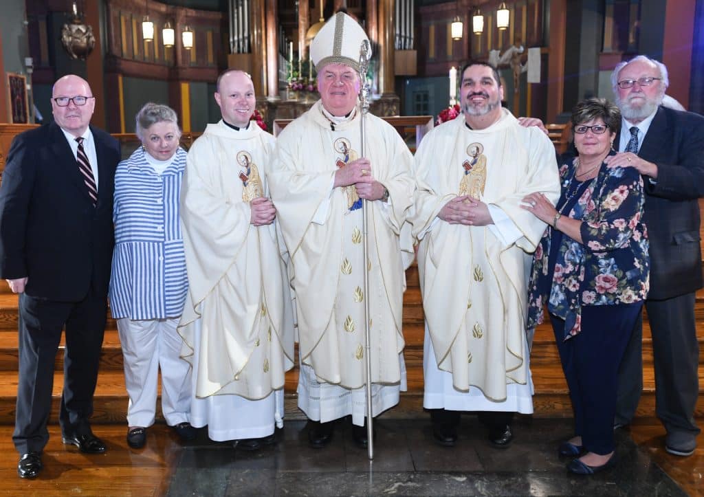 Brand new Paulist Fathers Michael Hennessy and Ryan Casey with Cardinal Tobin and their parents following the Ordination Mass