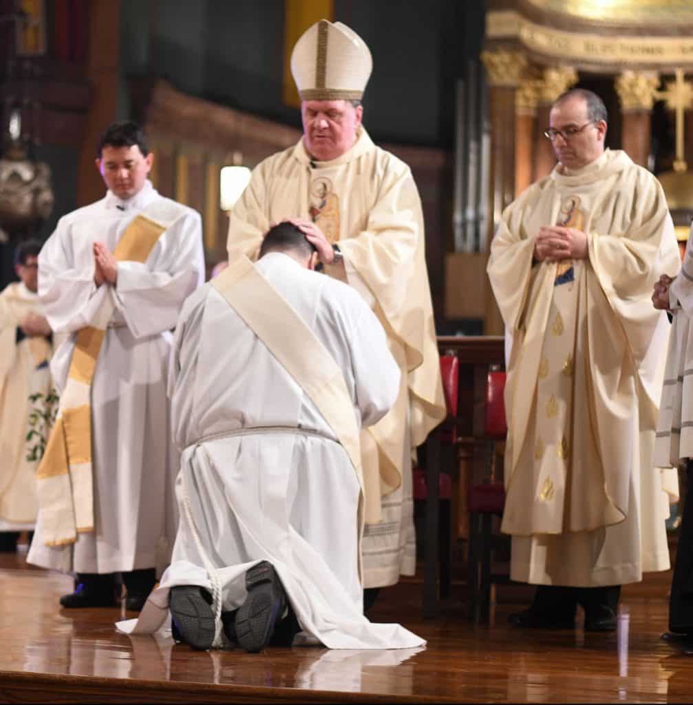 Cardinal Joseph Tobin, C.Ss.R., ordains Paulist Ryan Casey to the priesthood.